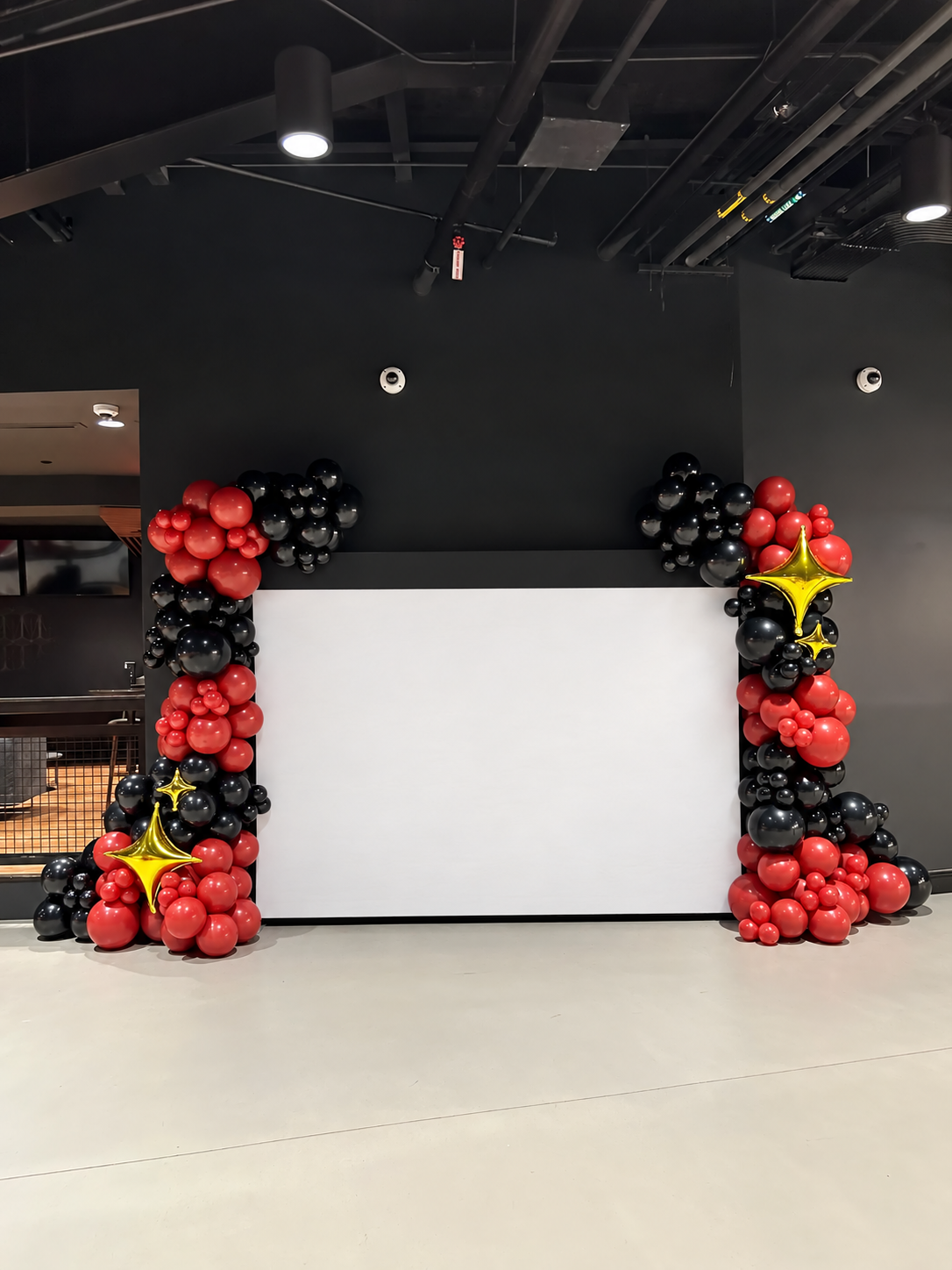 Large balloon garland installation around a presentation stage